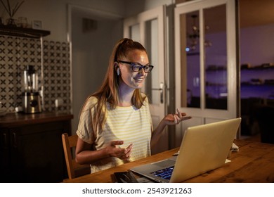 Young woman on a late night video call working remotely from home - Powered by Shutterstock