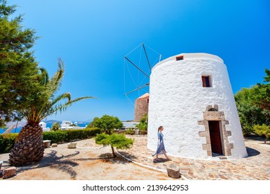 Young Woman On Milos Island Vacation In Greece Walking Closeby Traditional White Windmill