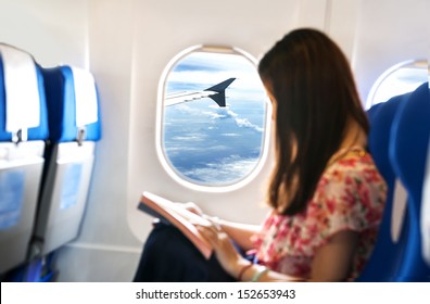 young woman is on passenger seat at airplane