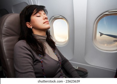 Young Woman Is On Passenger Seat At Airplane