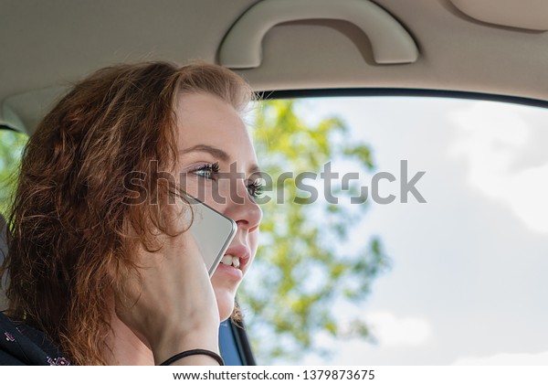 Young\
woman on the phone while driving is\
distracted