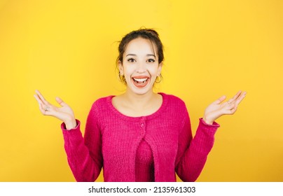 Young Woman On Pink Shirt Not Knowing What To Do Raising Hands. Young Woman Attitude. Yellow Tone Color Background, Expression Of Normal People. Mockup Concept With People