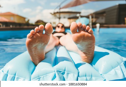 Young Woman On Pool Air Mattress In Above Ground Pool. Lifestyle At Home Concept.