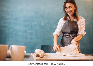 Young Woman On A Pottery Class Working With Rolling Pin