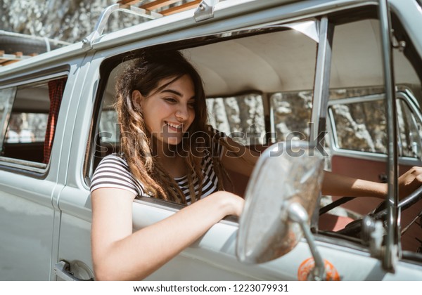 young woman on road trip on the beach. hipster\
freedom concept