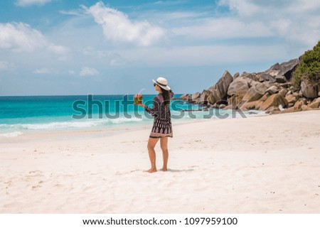young woman on vacation at the tropical island of the Seychelles, luxury holiday on the beach