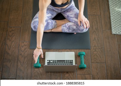 Young woman on yoga mat taking exercise class