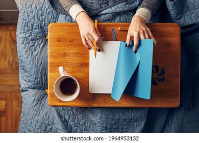 Young Woman Opening Diary, Writing Journal. Making Notes In Diary Sitting In Bed At Home