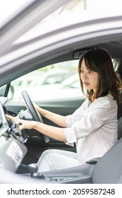 Young Woman Operating A Car Navigation System