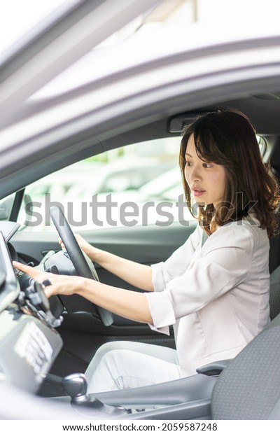 Young woman\
operating a car navigation\
system