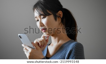 A young woman operating a cell phone.