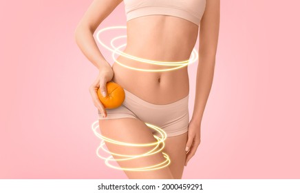 Young woman with orange fruit on color background. Concept of cellulite - Shutterstock ID 2000459291