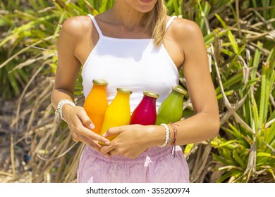 Young woman with Organic cold-pressed raw vegetable juice