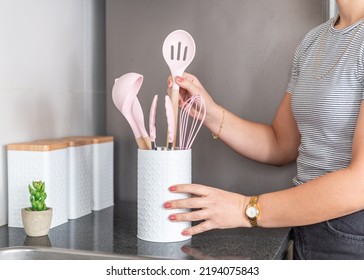 Young Woman Organizing Kitchen Utensils And Decorating