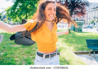 young woman outdoor having fun laughing spreading arms - getting away from it all, spontaneous, positive emotions concept - Shutterstock ID 1729338241