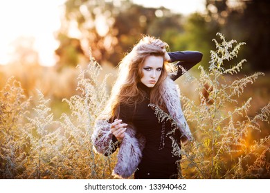 Young woman outdoors fashion portrait. Soft sunset light