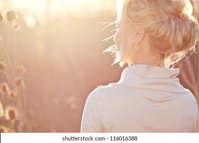 Young woman outdoors portrait. Soft sunny colors.