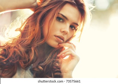 Young woman outdoors portrait. Soft sunny colors.