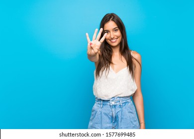Young woman over isolated blue background happy and counting four with fingers - Shutterstock ID 1577699485
