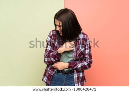 Young woman over isolated colorful wall smiling a lot
