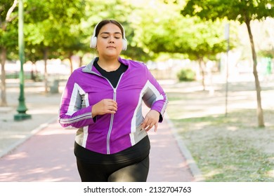 Young Woman With Overweight Enjoying A Run At The Park. Fat Hispanic Woman Doing A Cardio Workout