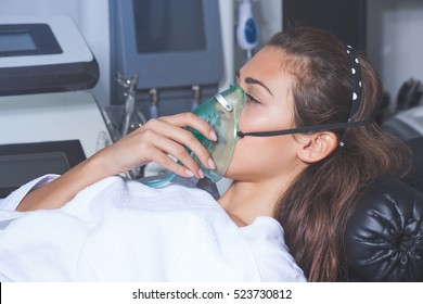 Young Woman With Oxygen Mask At Hospital Or Cosmetics Salon
