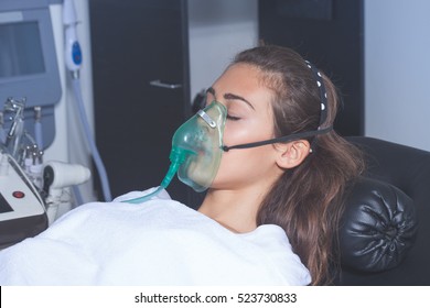 Young Woman With Oxygen Mask At Hospital Or Cosmetics Salon
