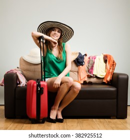 Young Woman Packing A Travel Bag On The Plane Before Going On Holiday. Gray Background, Easy To Remove.