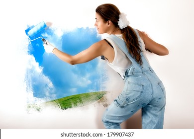 Young Woman Painting A Nature Landscape On Wall With Roller. Mural Painting On Wall. Ecologist