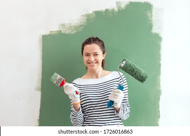 Young Woman Painting The Wall