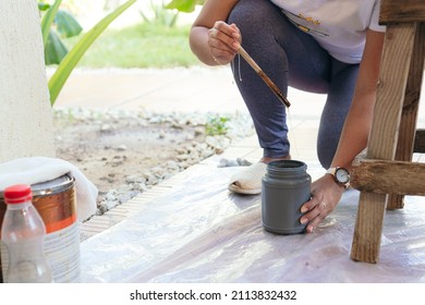 Young Woman Painting Wooden Chair