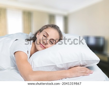 Young woman in pajamas sleeping on a soft mattress