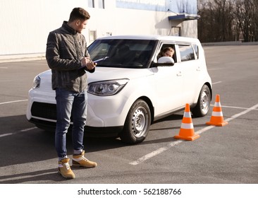 Young Woman Passing Driving License Exam Outdoors