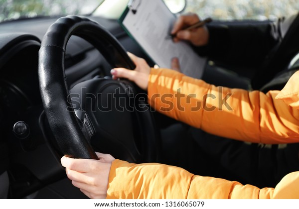 Young woman passing\
driving license test