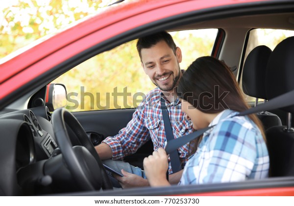 Young woman passing\
driving license exam