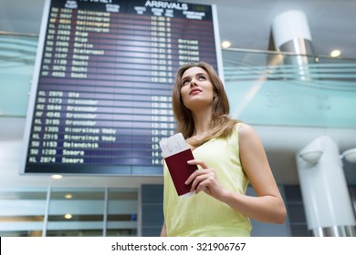 Young Woman With A Passport At The Board