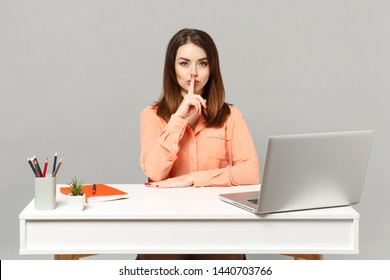 Young Woman In Pastel Clothes Say Hush Be Quiet With Finger On Lips Shhh Gesture Sit, Work At Desk With Pc Laptop Isolated On Gray Background. Achievement Business Career Concept. Mock Up Copy Space