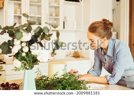 Similar – Woman makes wildflower bouquet in vase on the table