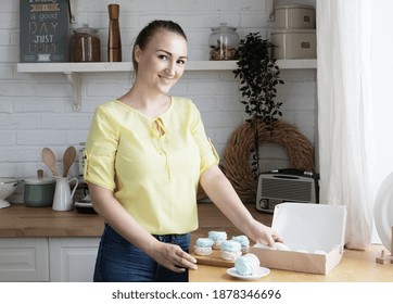 Young Woman Pastry Chef Puts Marshmallows In A Box. Small Home Business.