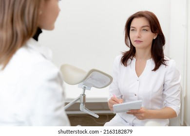 Young Woman Patient At Gynecologist Appointment Consults In Medical Institution.