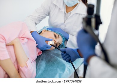 Young Woman Patient Lying On The Couch In Modern Clinic, Having Gastroscopic Examination Of The Stomach And Digestive Tract