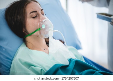 young woman patient receiving oxygen mask lying on a hospital bed, concept of medical and patient - Powered by Shutterstock