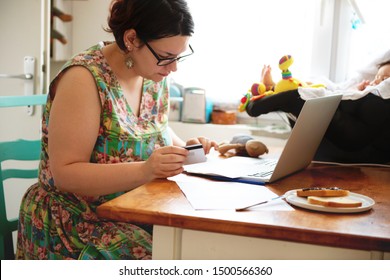 Young Woman Paying Bills Online From Home