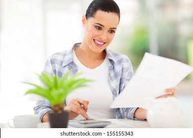 Young Woman Paying Her Bills At Home