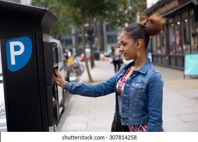 young woman paying her parking ticket