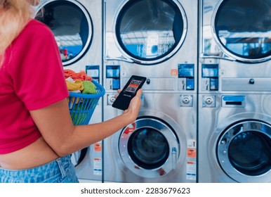 Young woman pays for laundry service using phone and banking application - Powered by Shutterstock