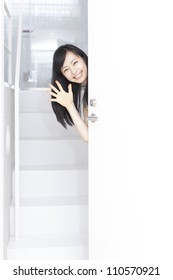 Young Woman Peeking Through Door