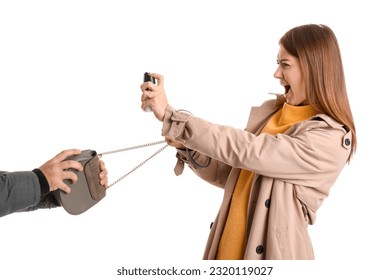 Young woman with pepper spray defending herself against thief on white background