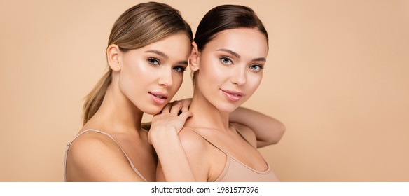 Young Woman With Perfect Skin Leaning On Shoulder Of Pretty Friend Isolated On Beige, Banner
