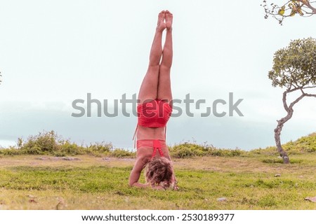Image, Stock Photo Flexible woman performing headstand pose in yoga studio